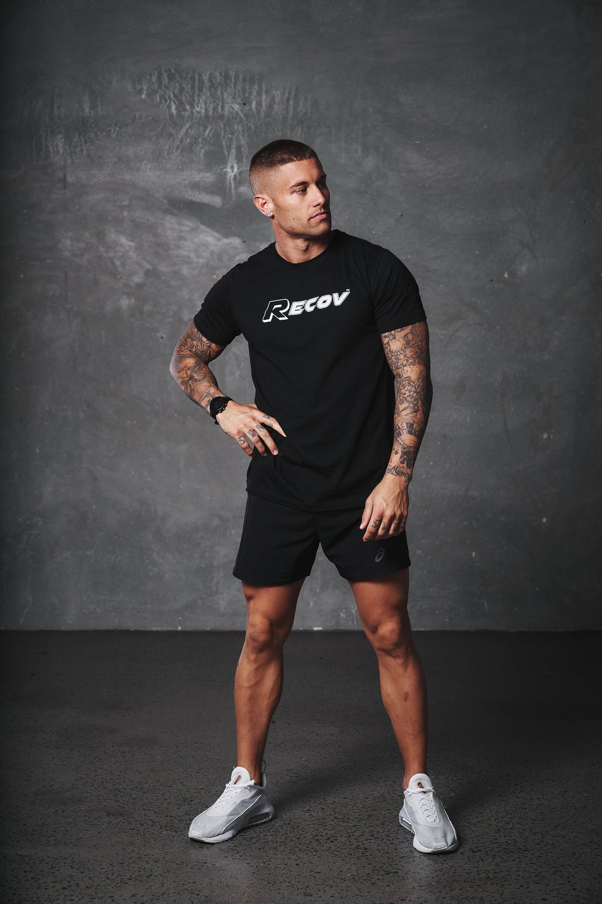 An athlete in a Recov training shirt standing in the gym