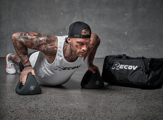 An athlete training beside a Recov gym bag