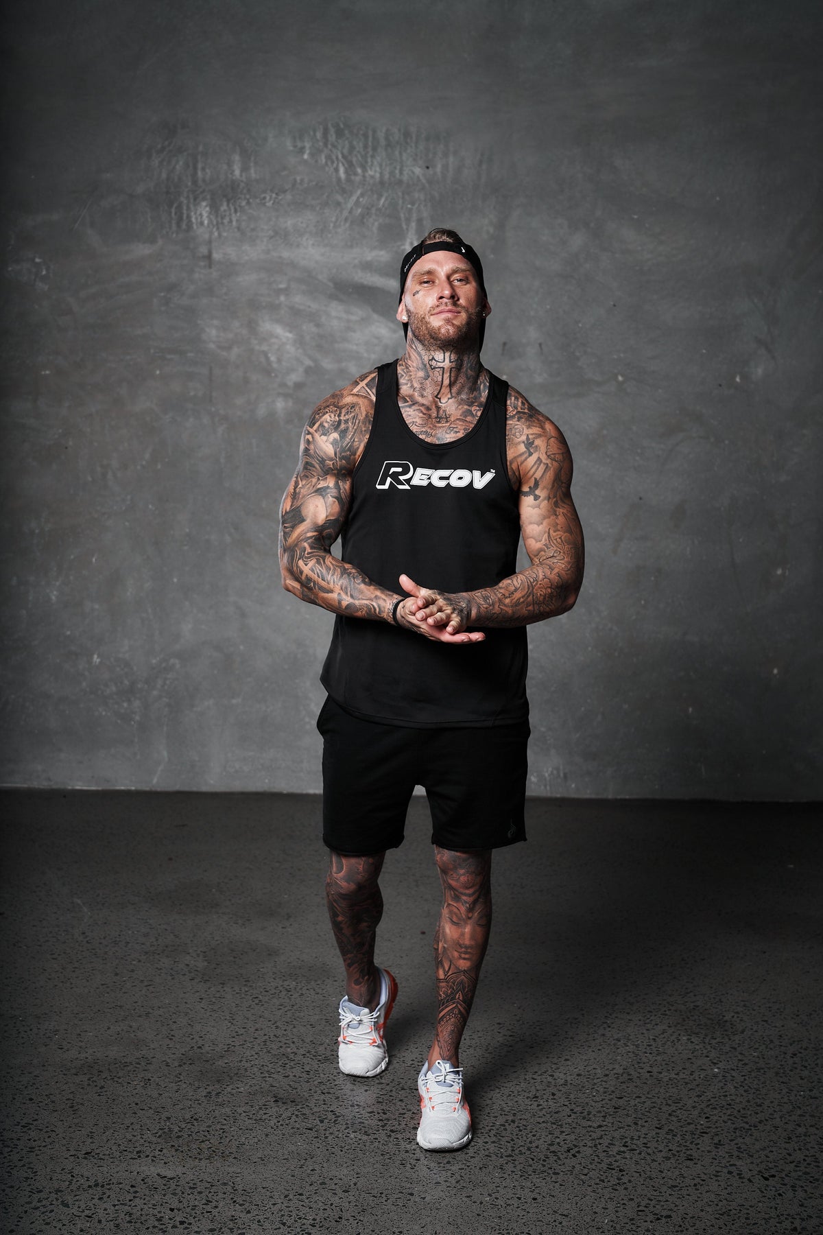 An athlete in a Recov training singlet standing in the gym