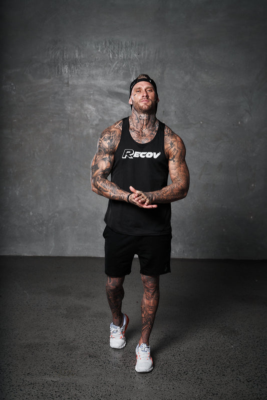An athlete in a Recov training singlet standing in the gym