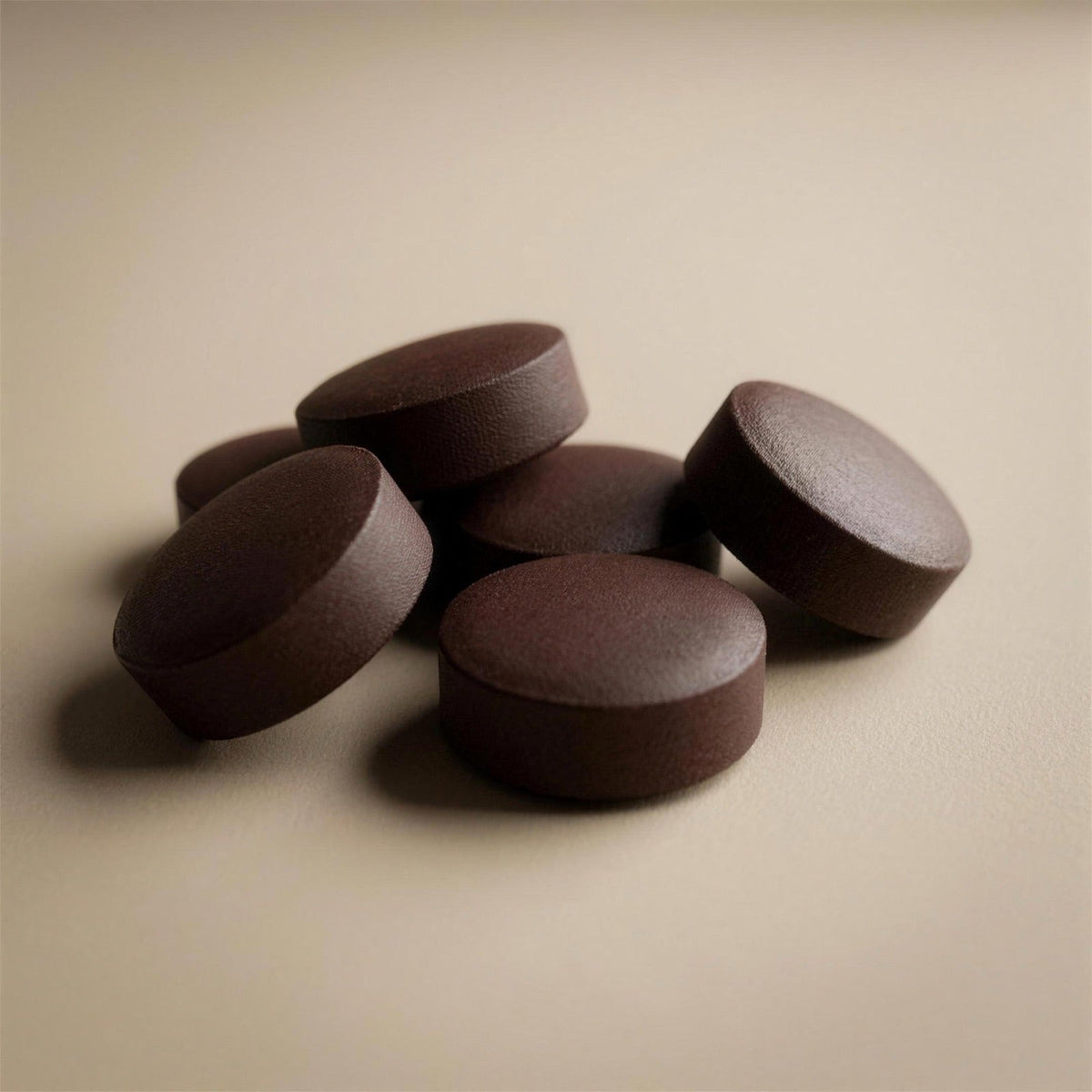 Close-up of Recov protein tablets on a light surface
