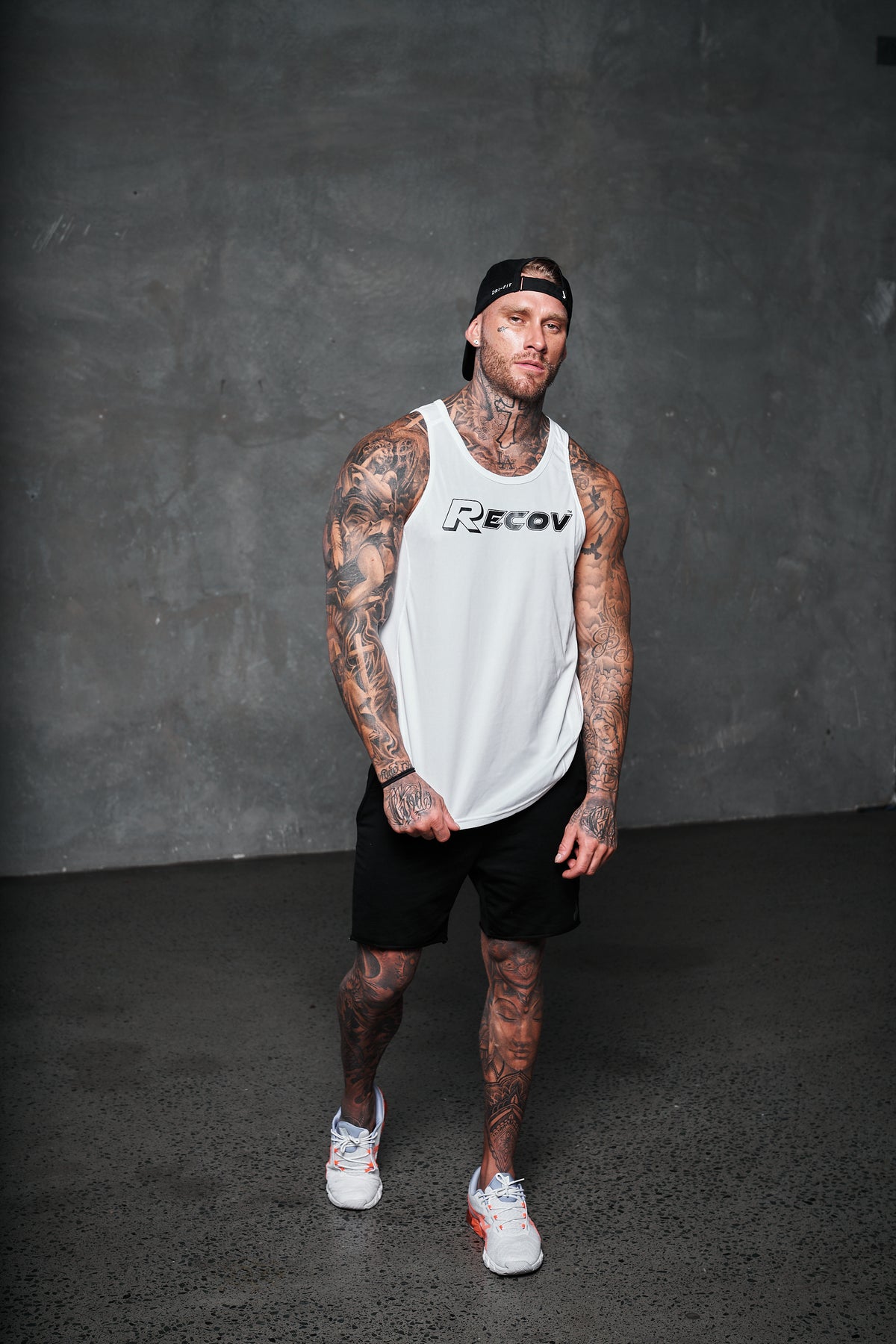Recov Active Singlet in white with black shorts